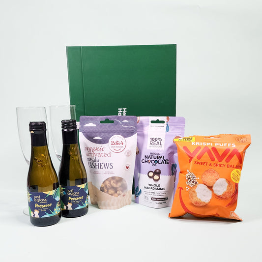 wine and gourmet items in front of green hamper box