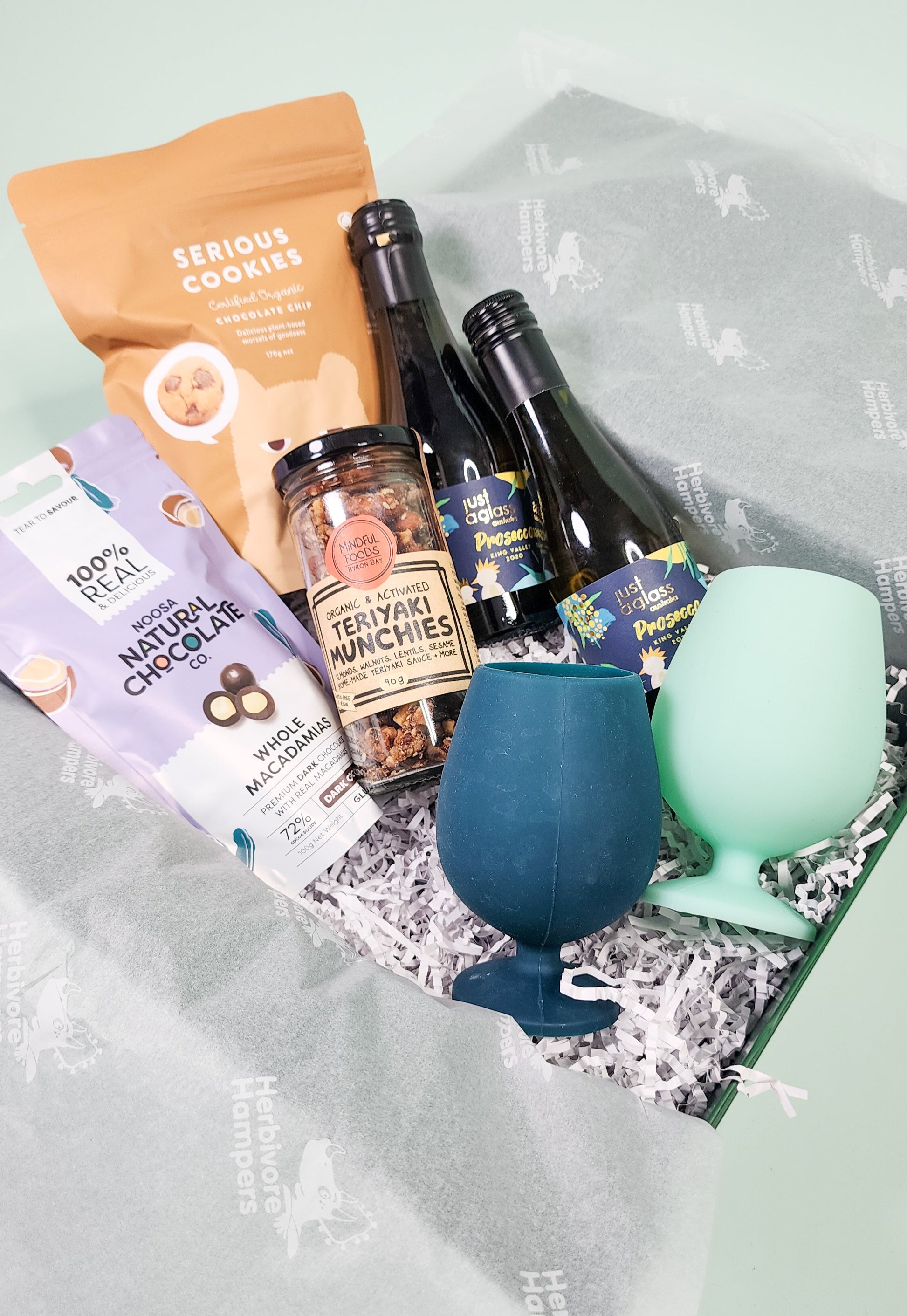 savoury hamper items in an open hamper box with tissue paper
